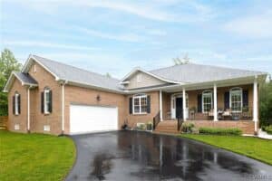 stunning brick home with black door and black shutters