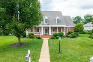 brick home with tree in front