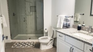 Recent home improvements remodeling a bathroom in white with neutral colors.